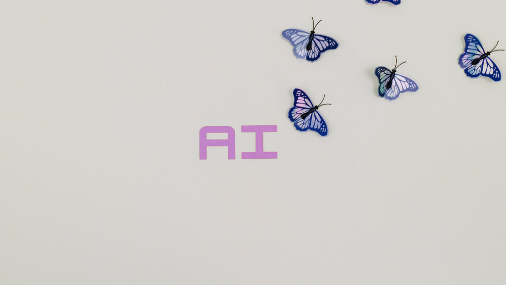 As letras AI, que significam Artificial Intelligence, e borboletas saindo da palavra significando a inteligência artificial e seus cuidados.